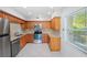 Condo kitchen with wood cabinets, granite counters, and stainless steel appliances at 301 Cordova Grn, Seminole, FL 33777