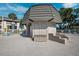 Community pool area with building and seating at 301 Cordova Grn, Seminole, FL 33777