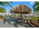 Outdoor patio area with picnic tables and thatched roof at 3010 59Th S St # 304, Gulfport, FL 33707