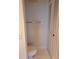 Small toilet and storage in a simple bathroom at 400 Island Way # 1508, Clearwater Beach, FL 33767