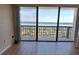 Living room showcasing panoramic water views and hardwood floors at 400 Island Way # 1508, Clearwater Beach, FL 33767
