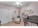 Well-designed Bedroom with crib, chair, and storage at 4506 Mapletree Loop, Wesley Chapel, FL 33544