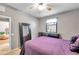 Bright bedroom with double bed, mirror and ceiling fan at 4506 Mapletree Loop, Wesley Chapel, FL 33544