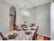 Dining room features a table set for six and a chandelier at 4506 Mapletree Loop, Wesley Chapel, FL 33544