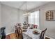 Bright dining room with wood floors, chandelier, and table set for a meal at 4506 Mapletree Loop, Wesley Chapel, FL 33544