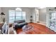 Living room with hardwood floors, sectional sofa, and glass top coffee table at 4506 Mapletree Loop, Wesley Chapel, FL 33544