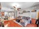 Open living room with hardwood floors, a view of the kitchen and dining area at 4506 Mapletree Loop, Wesley Chapel, FL 33544