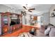 Spacious living room with hardwood floors and a view into the kitchen and dining area at 4506 Mapletree Loop, Wesley Chapel, FL 33544