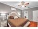 Main bedroom with king bed, dressers and a view of the bathroom at 4506 Mapletree Loop, Wesley Chapel, FL 33544