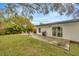 Large backyard with patio, grill, firepit, and lush landscaping at 4519 S Hesperides St, Tampa, FL 33611