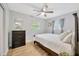 Spacious bedroom with dresser, double bed, and ceiling fan at 4519 S Hesperides St, Tampa, FL 33611