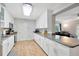 Eat-in kitchen with white cabinets, granite countertops, and open layout at 4519 S Hesperides St, Tampa, FL 33611