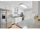 Modern kitchen with white cabinets, stainless steel appliances, and granite counters at 4519 S Hesperides St, Tampa, FL 33611
