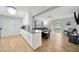 Open concept kitchen and living area with wood-look floors and patio access at 4519 S Hesperides St, Tampa, FL 33611