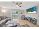 Bright and airy living room with large TV and access to backyard patio at 4519 S Hesperides St, Tampa, FL 33611