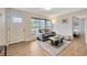 Cozy living room with gray couch, wood floors, and view of bedroom at 4519 S Hesperides St, Tampa, FL 33611