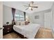 King-size bed in a spacious bedroom with ceiling fan and wood floors at 4519 S Hesperides St, Tampa, FL 33611
