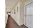 Clean condo hallway with carpet, showing a white door to a unit at 4575 Cove Cir # 407, St Petersburg, FL 33708