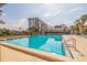 Refreshing community pool with surrounding lounge chairs at 5400 Park N St # 209, St Petersburg, FL 33709
