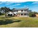 Two-story house with a metal roof, front porch, and grassy yard at 5604 Miley Rd, Plant City, FL 33565