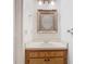 Small bathroom with wood vanity and ornate mirror at 5832 Red Cedar Ln, Tampa, FL 33625