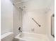 Bathroom with tub, shower, and grab bars for accessibility at 5832 Red Cedar Ln, Tampa, FL 33625