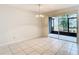 Bright dining room with tile floors and access to a screened patio at 5832 Red Cedar Ln, Tampa, FL 33625