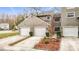 Townhouse exterior showcasing three-car garage and landscaping at 5832 Red Cedar Ln, Tampa, FL 33625
