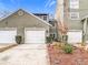 Townhouse exterior with two-car garage and landscaping at 5832 Red Cedar Ln, Tampa, FL 33625