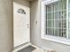 White front door with a window and sidelights at 5832 Red Cedar Ln, Tampa, FL 33625