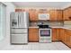 Kitchen with stainless steel appliances and wood cabinets at 5832 Red Cedar Ln, Tampa, FL 33625