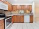Kitchen features wood cabinets, granite countertops, and stainless steel appliances at 5832 Red Cedar Ln, Tampa, FL 33625