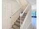 Carpeted staircase with a white railing at 5832 Red Cedar Ln, Tampa, FL 33625