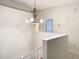 Upstairs hallway with chandelier and view of staircase at 5832 Red Cedar Ln, Tampa, FL 33625