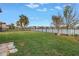 Spacious backyard with lake view, lush lawn, and a bench at 6216 Kevesta Ave, Palmetto, FL 34221