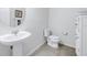 Clean and modern bathroom with pedestal sink and storage cabinet at 6216 Kevesta Ave, Palmetto, FL 34221