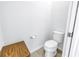 Small half bathroom with toilet and wooden bench at 6216 Kevesta Ave, Palmetto, FL 34221