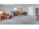 Bright bonus room with leather sofas and a view of the stairs at 6216 Kevesta Ave, Palmetto, FL 34221