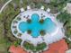 Aerial view of resort-style pool with palm trees and lounge areas at 6216 Kevesta Ave, Palmetto, FL 34221