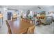 Open concept dining area with wood table and chairs, adjacent to living room at 6216 Kevesta Ave, Palmetto, FL 34221