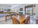 Bright dining area with wood table and chairs, near sliding glass doors to patio at 6216 Kevesta Ave, Palmetto, FL 34221