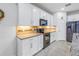 Modern kitchen featuring white cabinets, granite countertops, and black appliances at 6216 Kevesta Ave, Palmetto, FL 34221