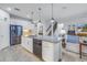 Open concept kitchen with island, stainless steel appliances, and granite countertops at 6216 Kevesta Ave, Palmetto, FL 34221