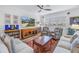 Living room with large windows, comfortable seating, and a TV at 6216 Kevesta Ave, Palmetto, FL 34221