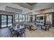 A well-lit resident lounge area with comfortable seating, large windows with a pool view and an elegant chandelier at 6216 Kevesta Ave, Palmetto, FL 34221