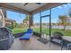 Relaxing screened porch overlooking a lake with outdoor furniture at 6216 Kevesta Ave, Palmetto, FL 34221