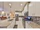 Kitchen with white cabinets, granite counters, and stainless steel appliances at 6217 Colmar Pl, Apollo Beach, FL 33572