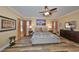 Spacious main bedroom featuring wood-look floors and ceiling fan at 6217 Colmar Pl, Apollo Beach, FL 33572