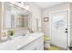 Bathroom with white vanity, toilet and exterior access at 6518 Senegal Palm Way, Apollo Beach, FL 33572