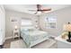 Guest bedroom with a queen-size bed and coastal decor at 6518 Senegal Palm Way, Apollo Beach, FL 33572